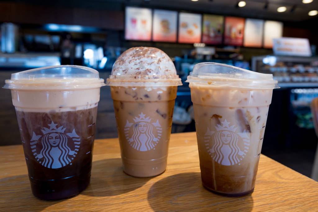 A batch of pumpkin spice lattes, iced pumpkin cream and fresh apple espresso oat milk shakes on a table at Starbucks